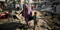 Image: Palestinians on a damaged Gaza City street