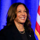 Kamala Harris waves on stage