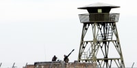 Iranian soldiers stand guard on an anti-aircraft machine gun inside Natanz uranium enrichment facility