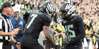 Oregon Ducks wide receiver Tez Johnson (15) celebrates a touchdown by Oregon Ducks wide receiver Evan Stewart (7) in the second quarter during a game against the Ohio State Buckeyes on Saturday. 