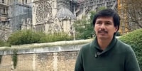 Alejandro Arredondo stands near the Notre Dame, seen in the background