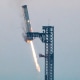  SpaceX successfully "caught" the first-stage booster of its Starship megarocket Sunday as it returned to the launch pad after a test flight, a world first in the company's quest for rapid reusability.